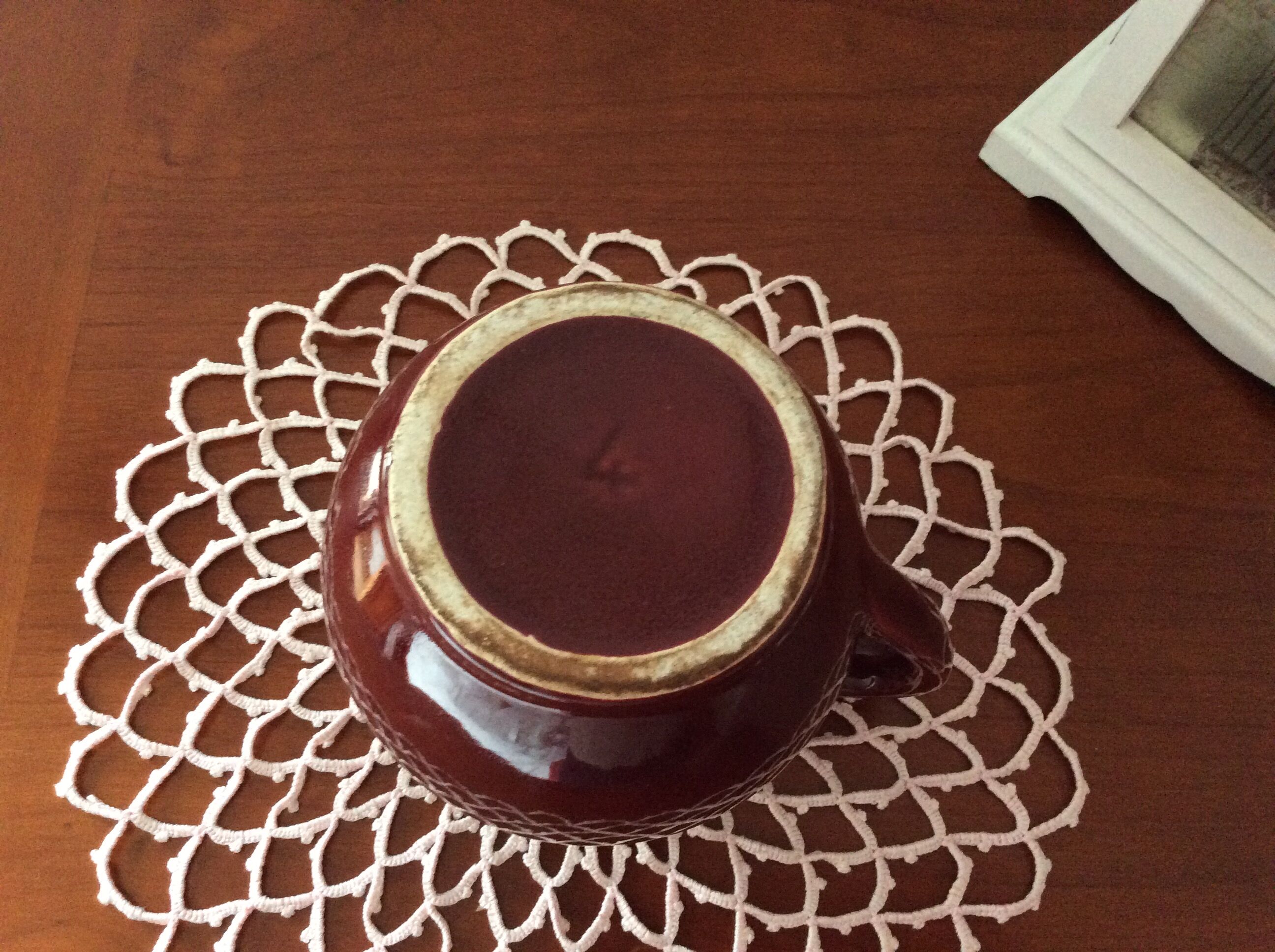 Old dark red ceramic pitcher jug