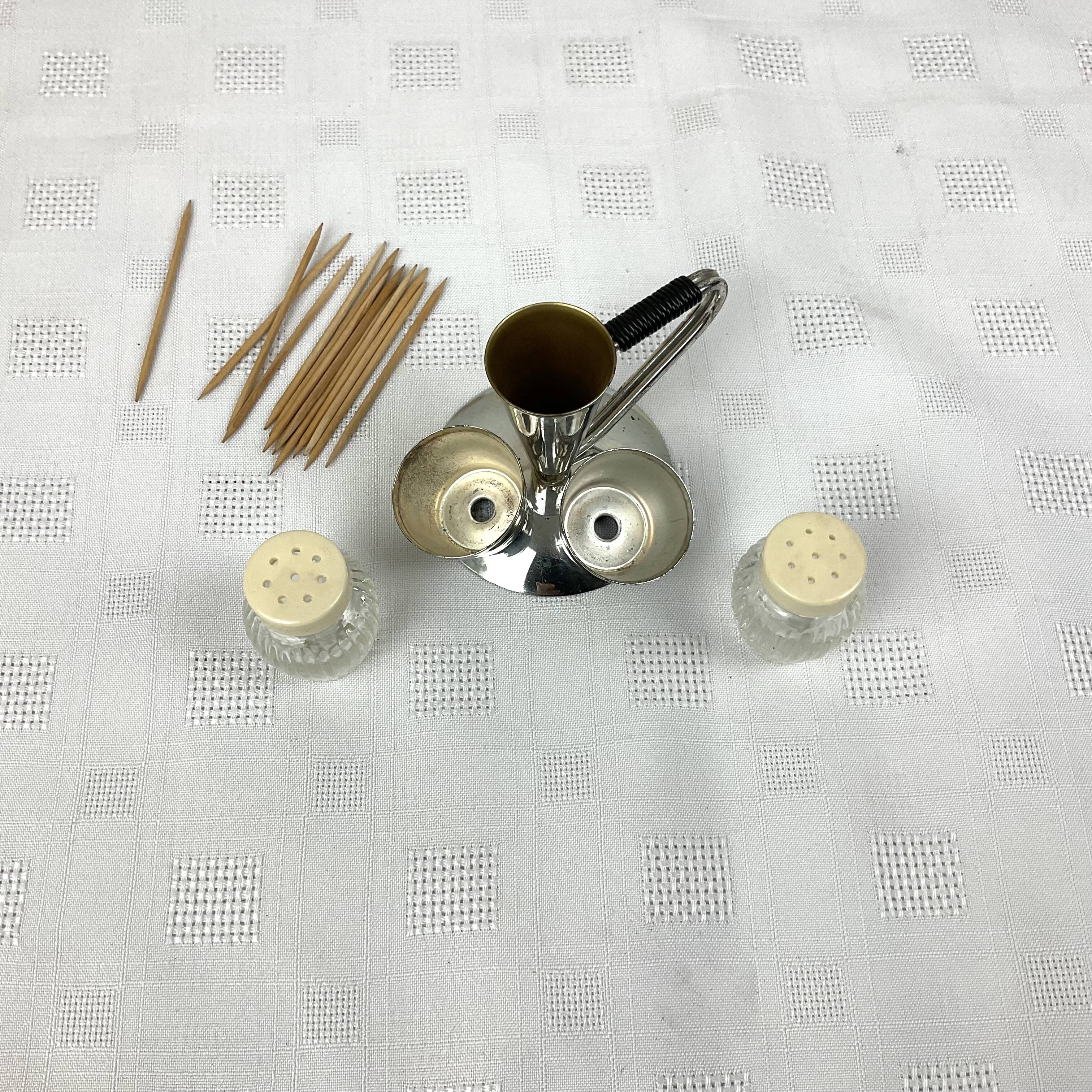 Vintage salt and pepper shakers and their chrome metal support