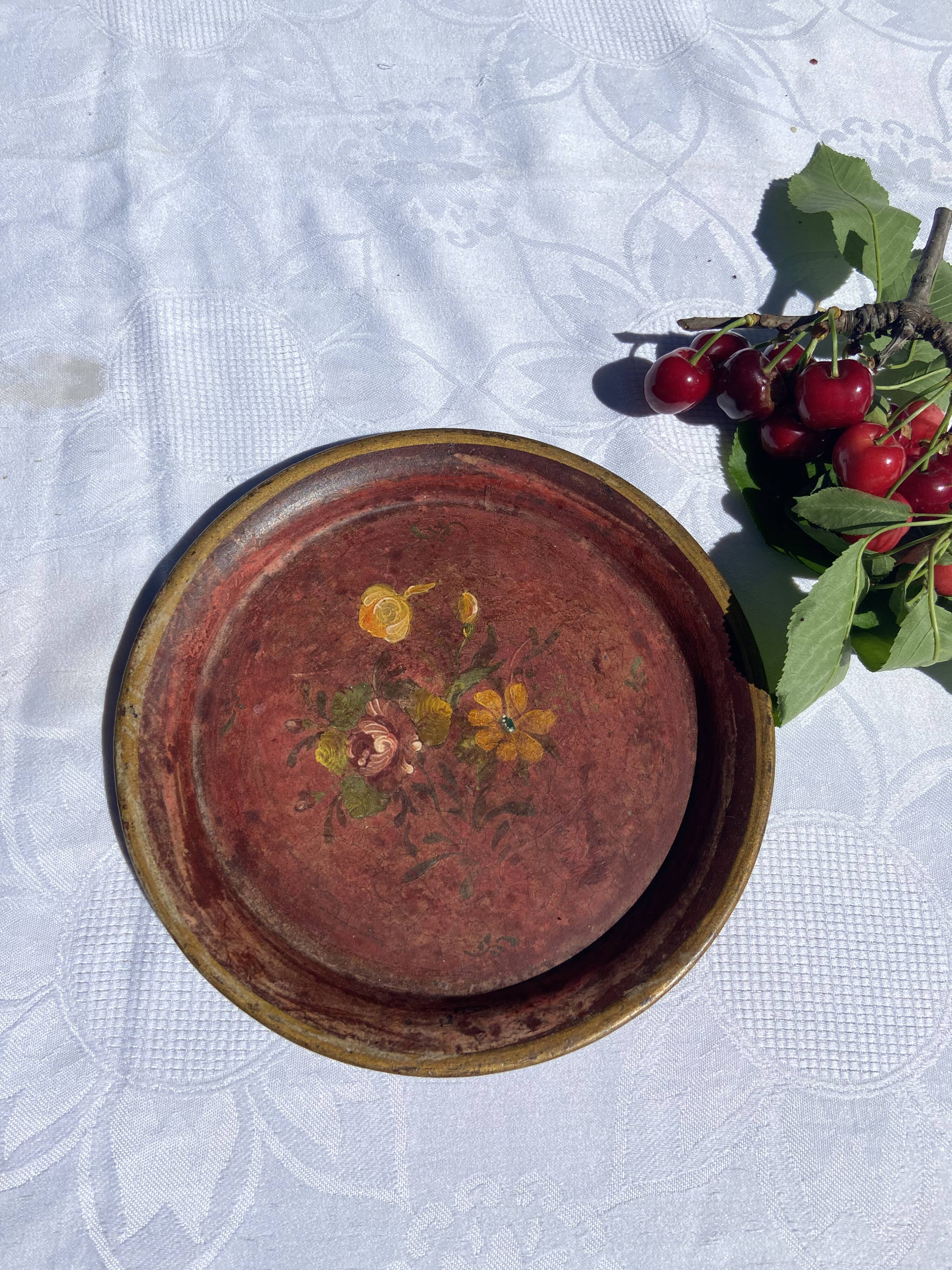 Small antique lacquered dish with hand-painted floral decoration.