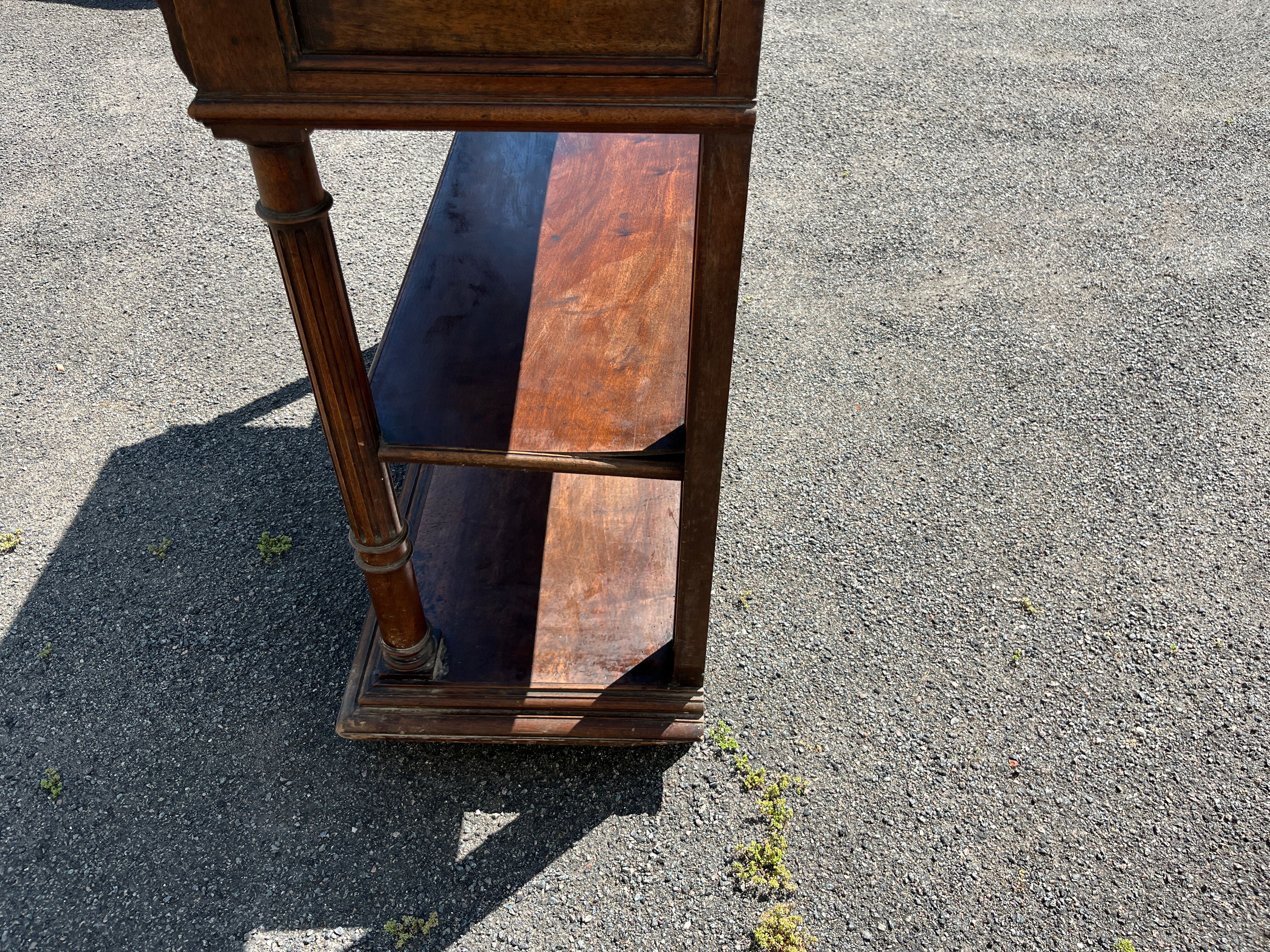 Carved wooden console table with three shelves and drop-leaf flap