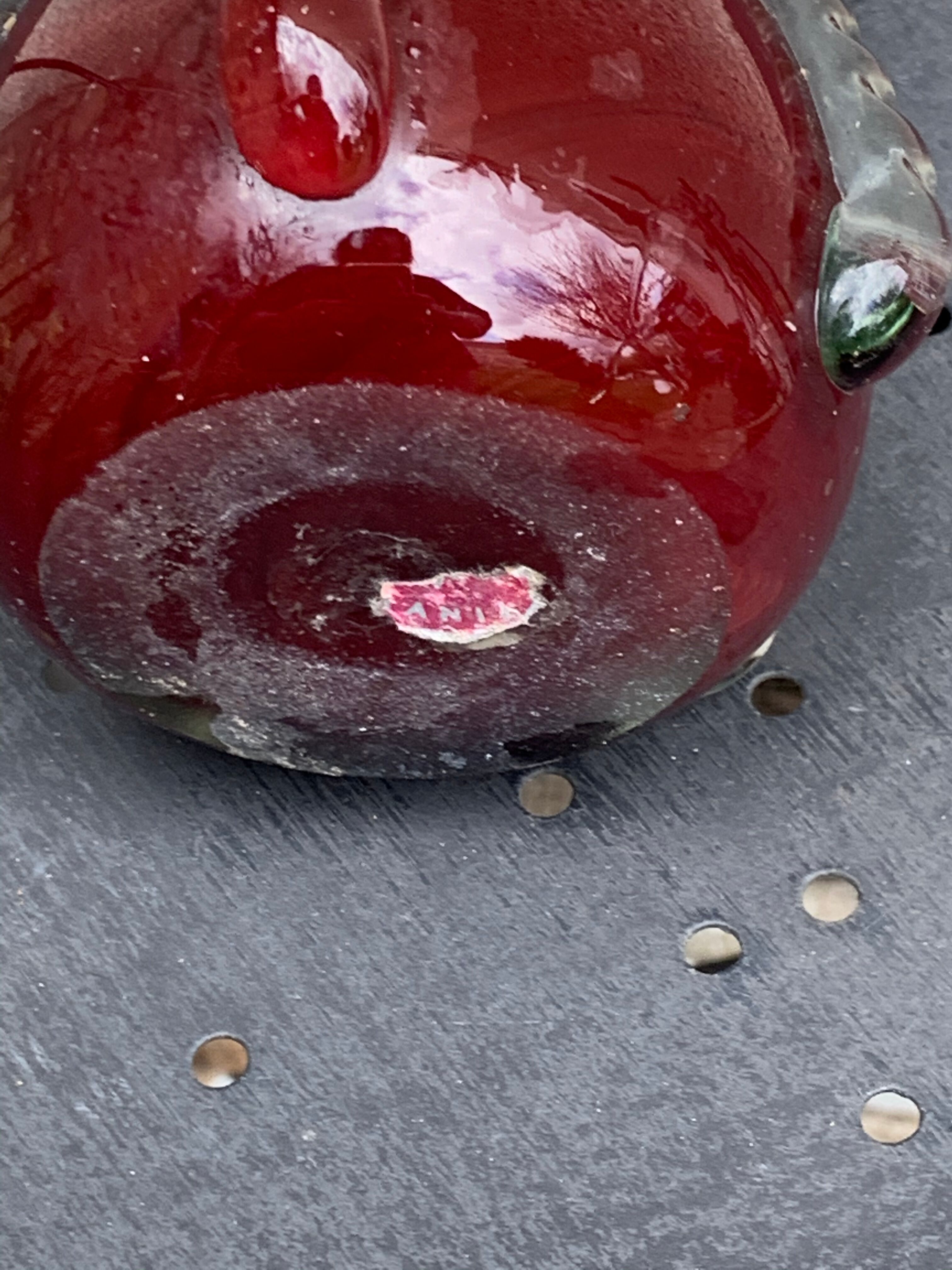 Burgundy red blown glass vase in the shape of a vintage corolla