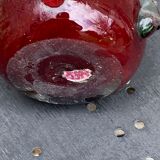 Burgundy red blown glass vase in the shape of a vintage corolla