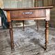 Antique Louis Philippe style farm table in solid cherry wood with turned base.