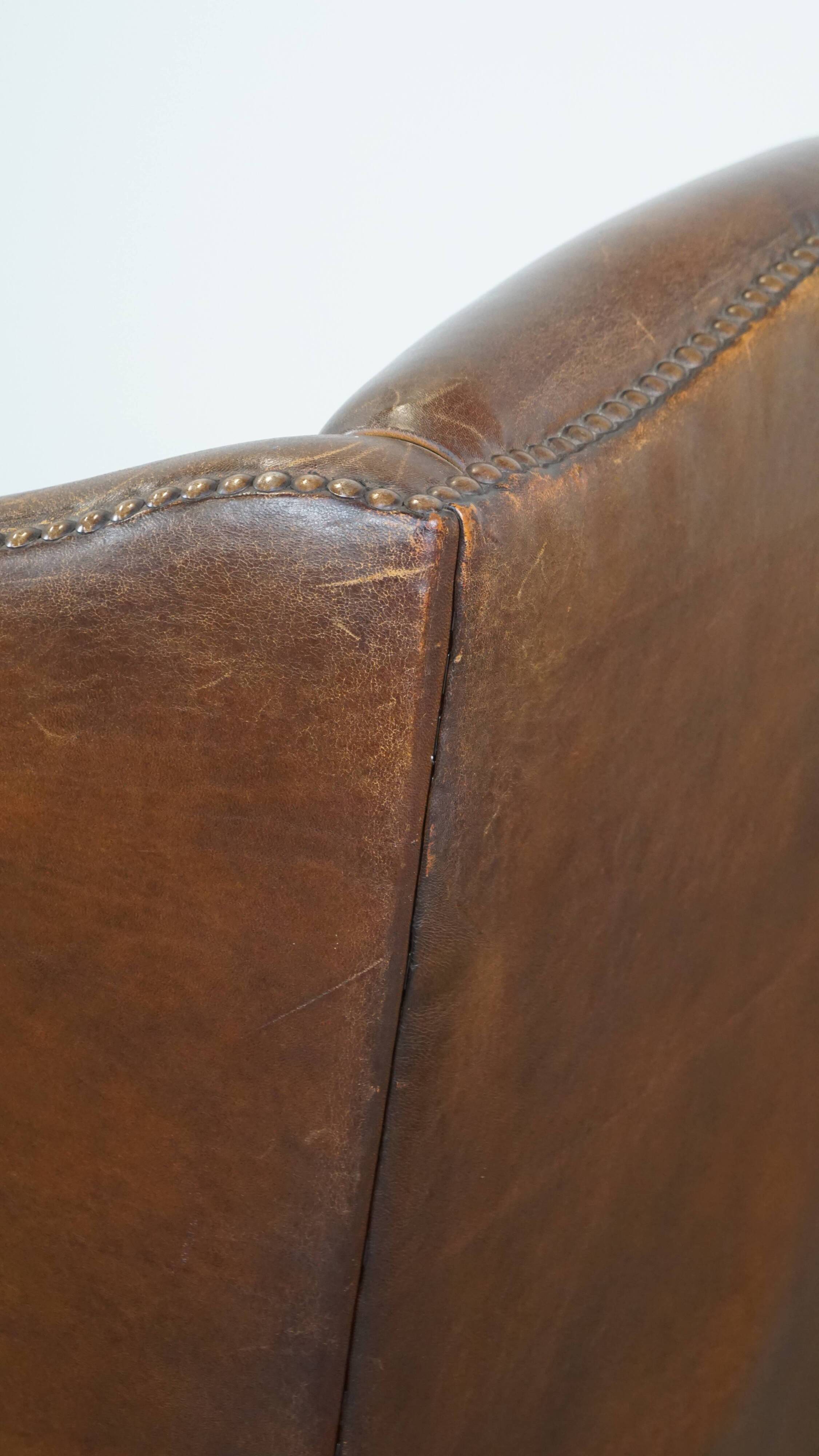 Cognac-colored sheepskin wing chair in English style