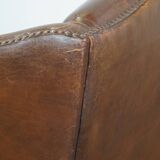 Cognac-colored sheepskin wing chair in English style