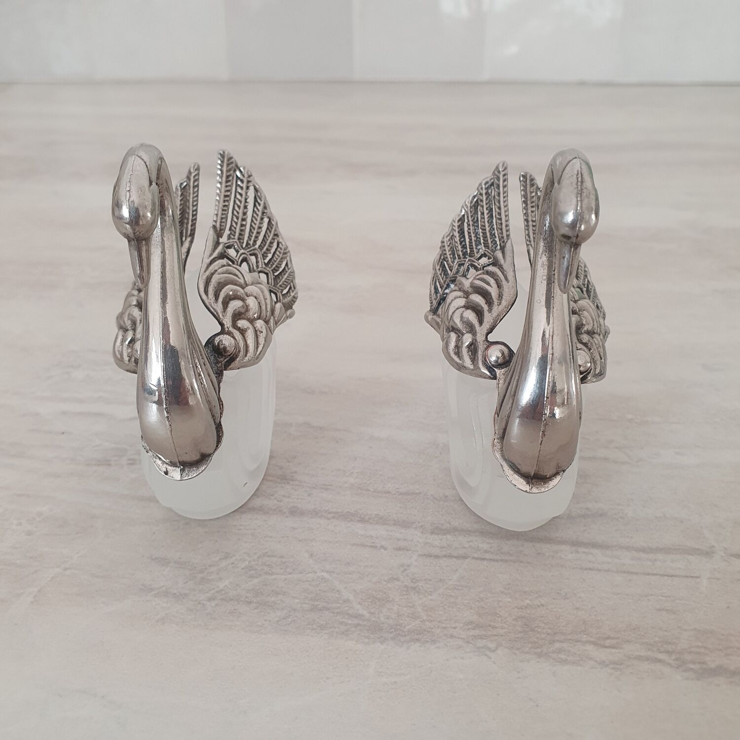 Two frosted glass swan salt cellars with silver plating.