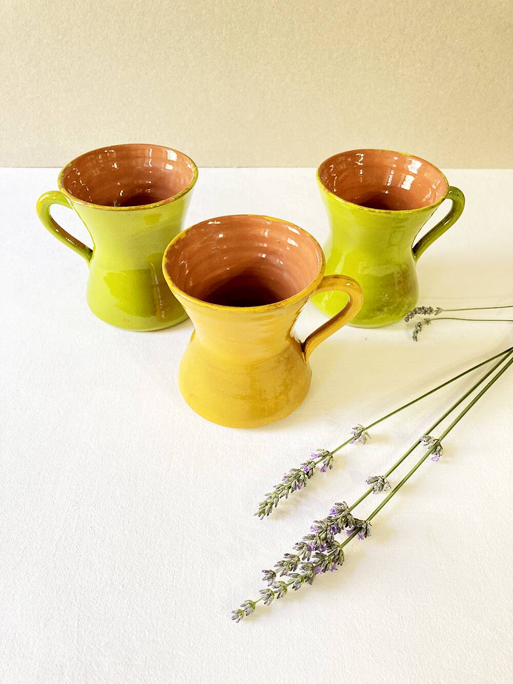 3 large green and yellow enameled ceramic cups, signed