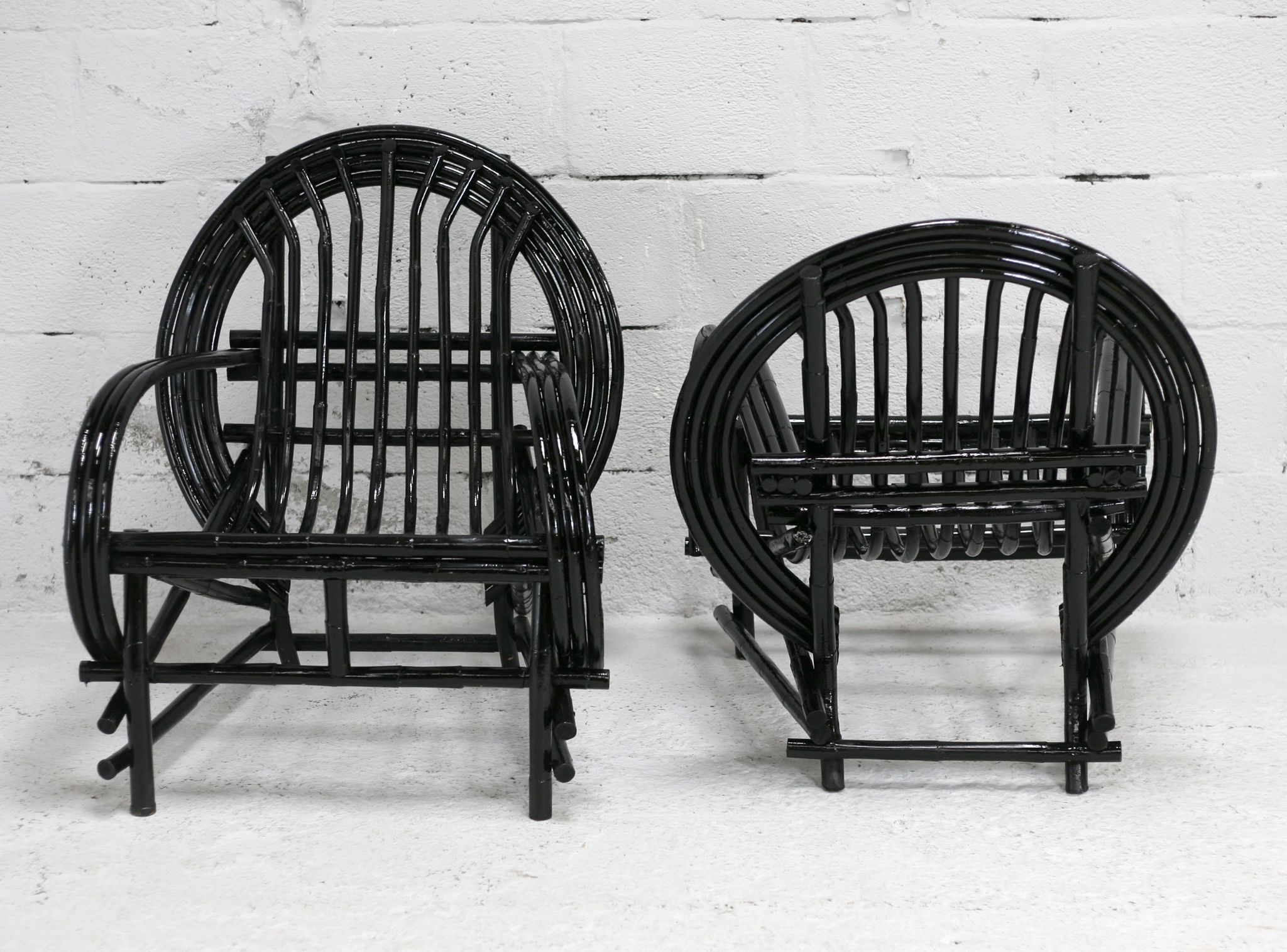 Pair of black lacquered rattan armchairs. France, cira 1960.