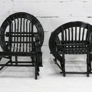 Pair of black lacquered rattan armchairs. France, cira 1960.