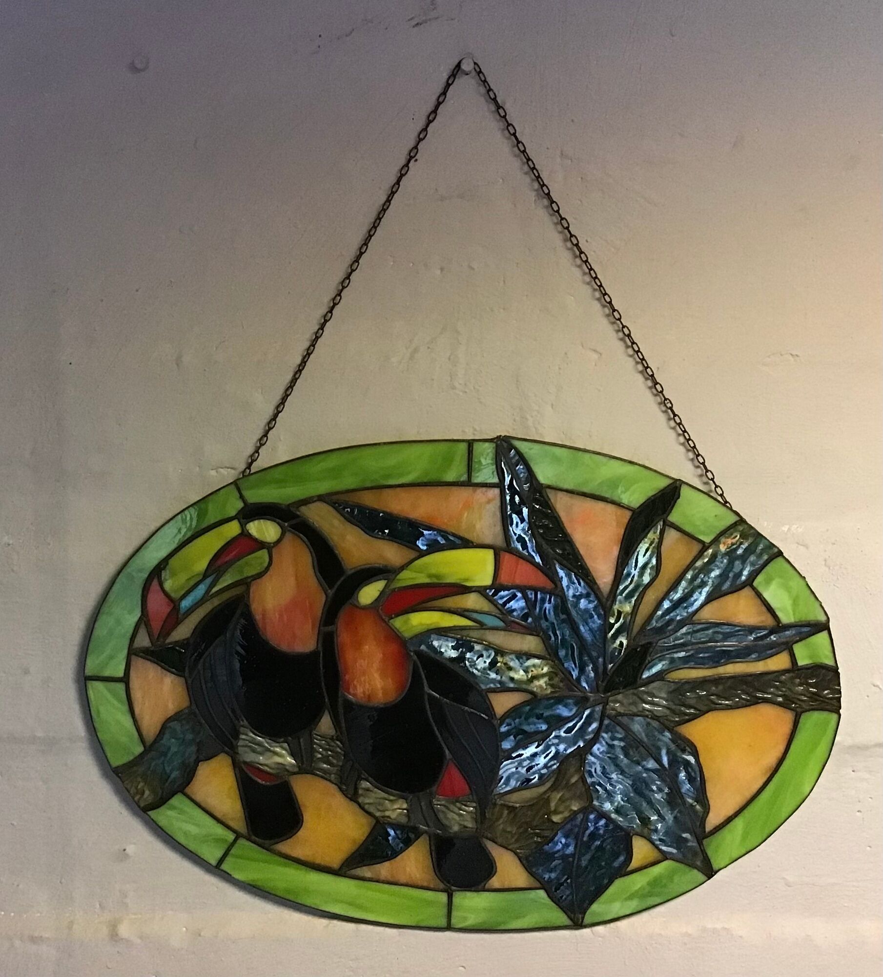 Art Deco style stained glass window representing a couple of toucans