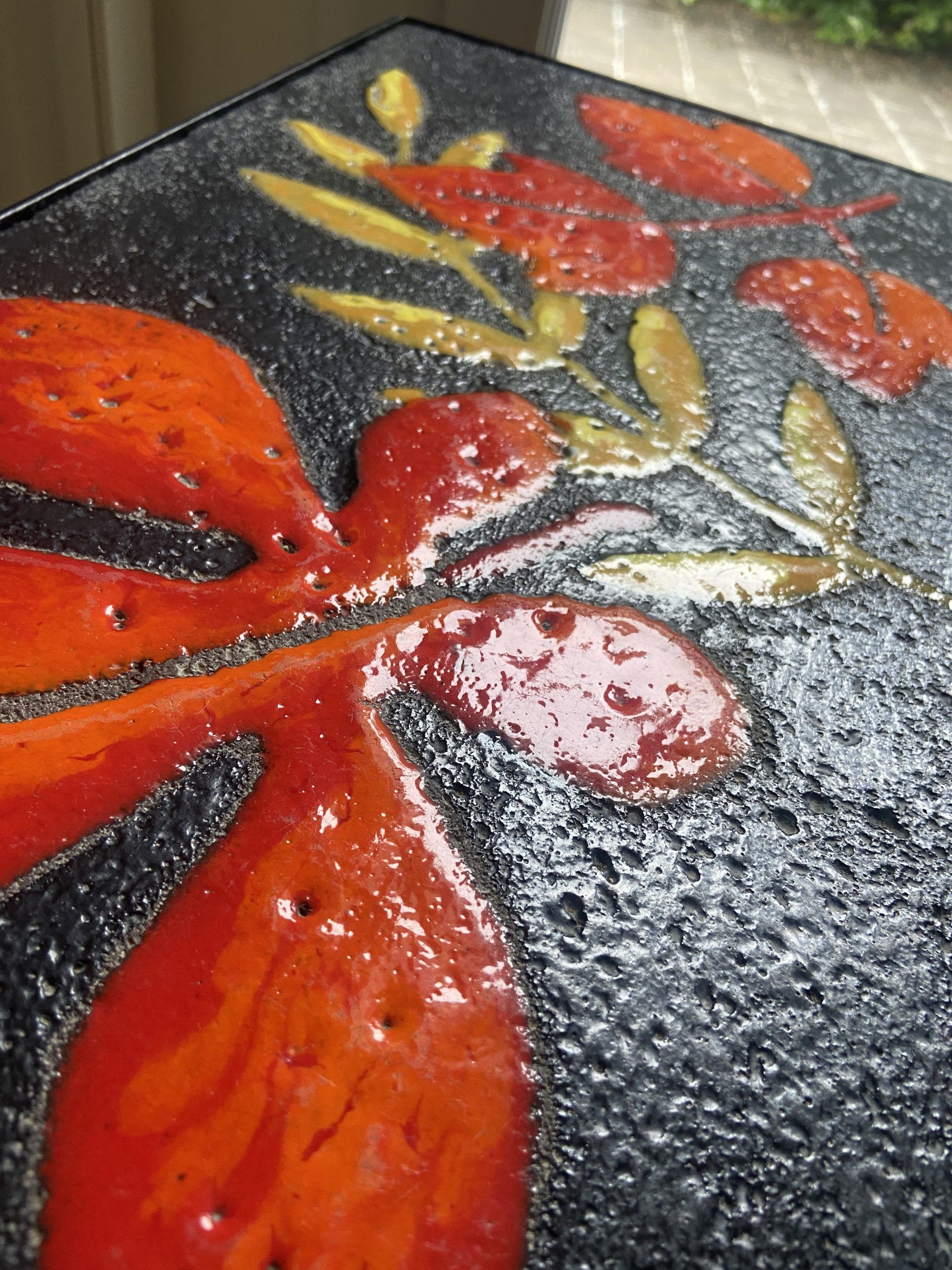 Side table or end of sofa in wrought iron and enamelled lava stone circa 1960