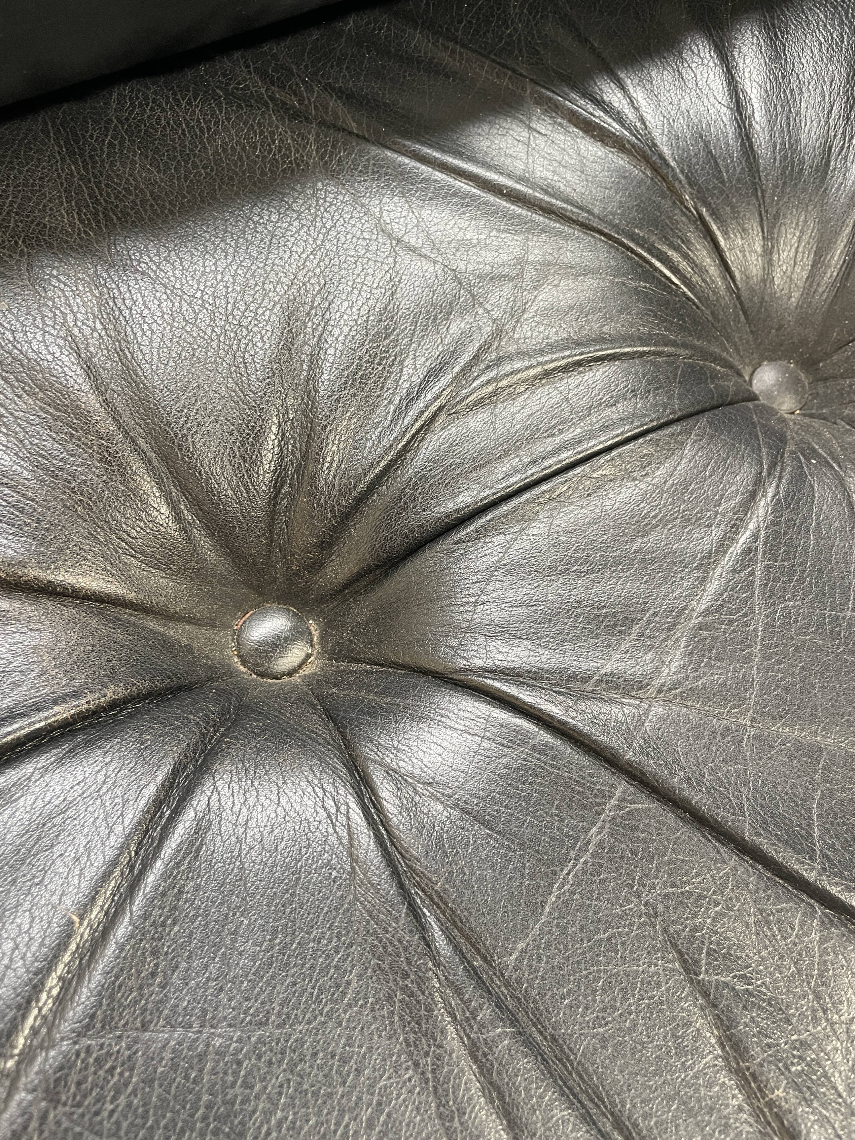 Pair of black leather armchairs
