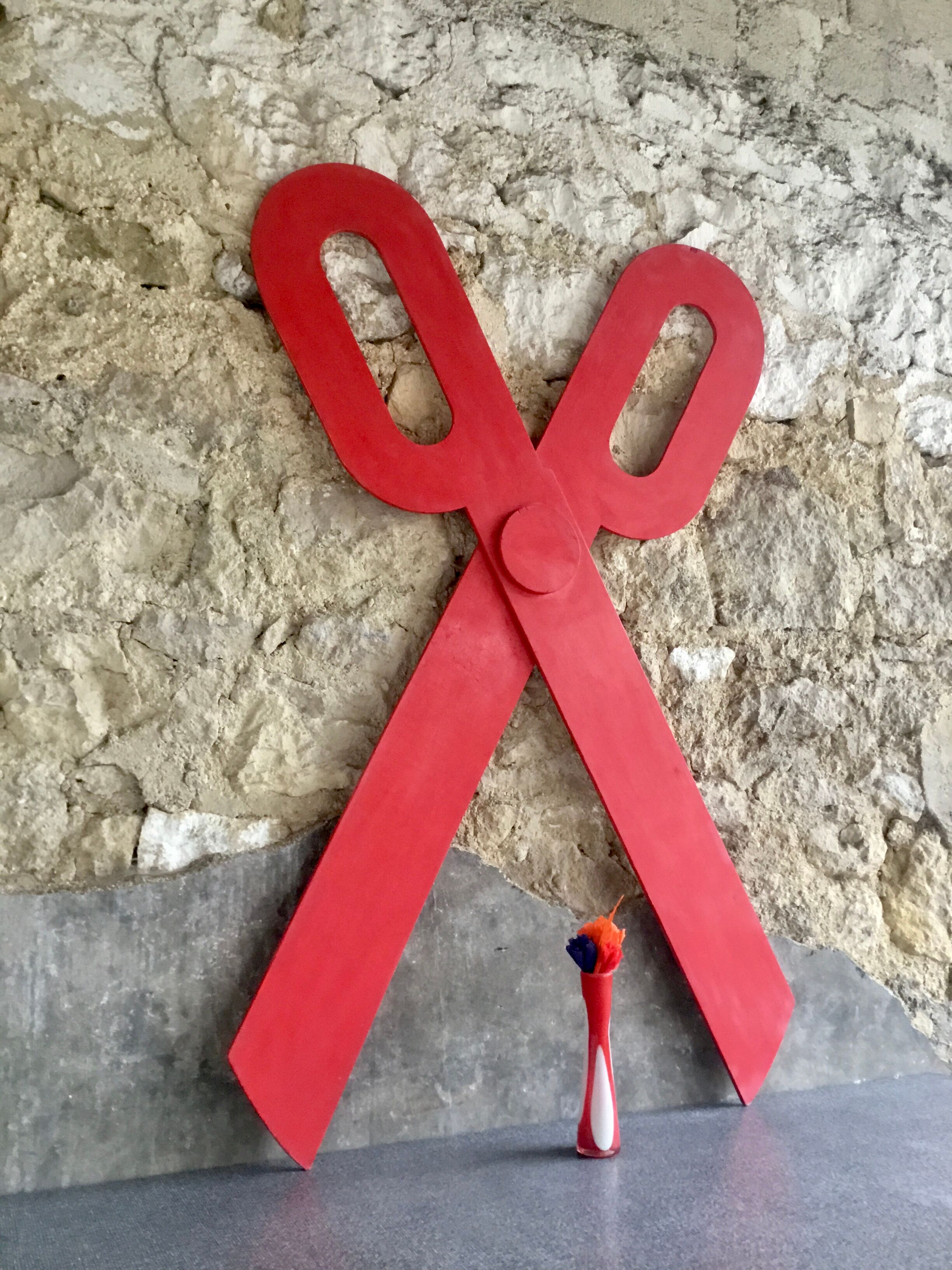 Wooden sign in the shape of scissors
