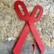 Wooden sign in the shape of scissors
