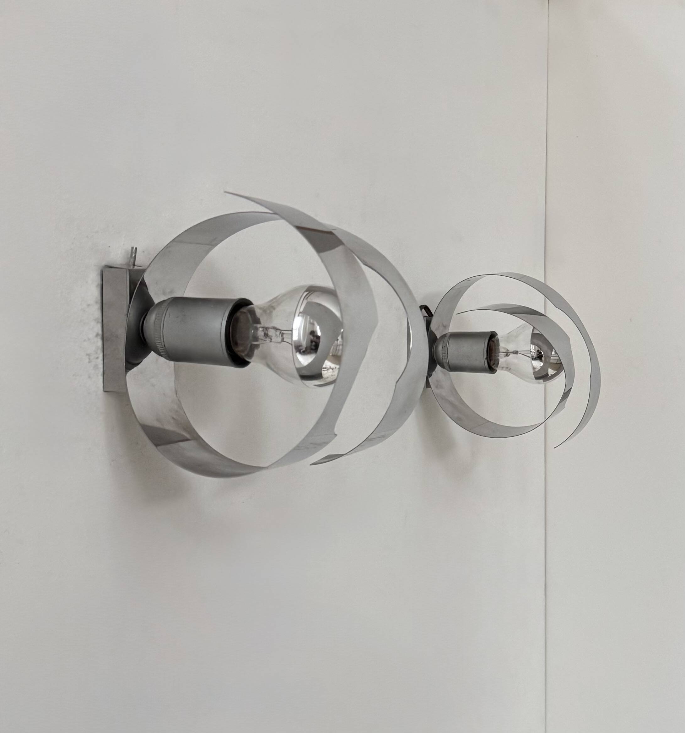 Pair of vintage wall sconces, curved chrome-plated metal, France, 1970