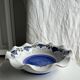 Small hand-painted earthenware salad bowl with garland of blue flowers, mark below