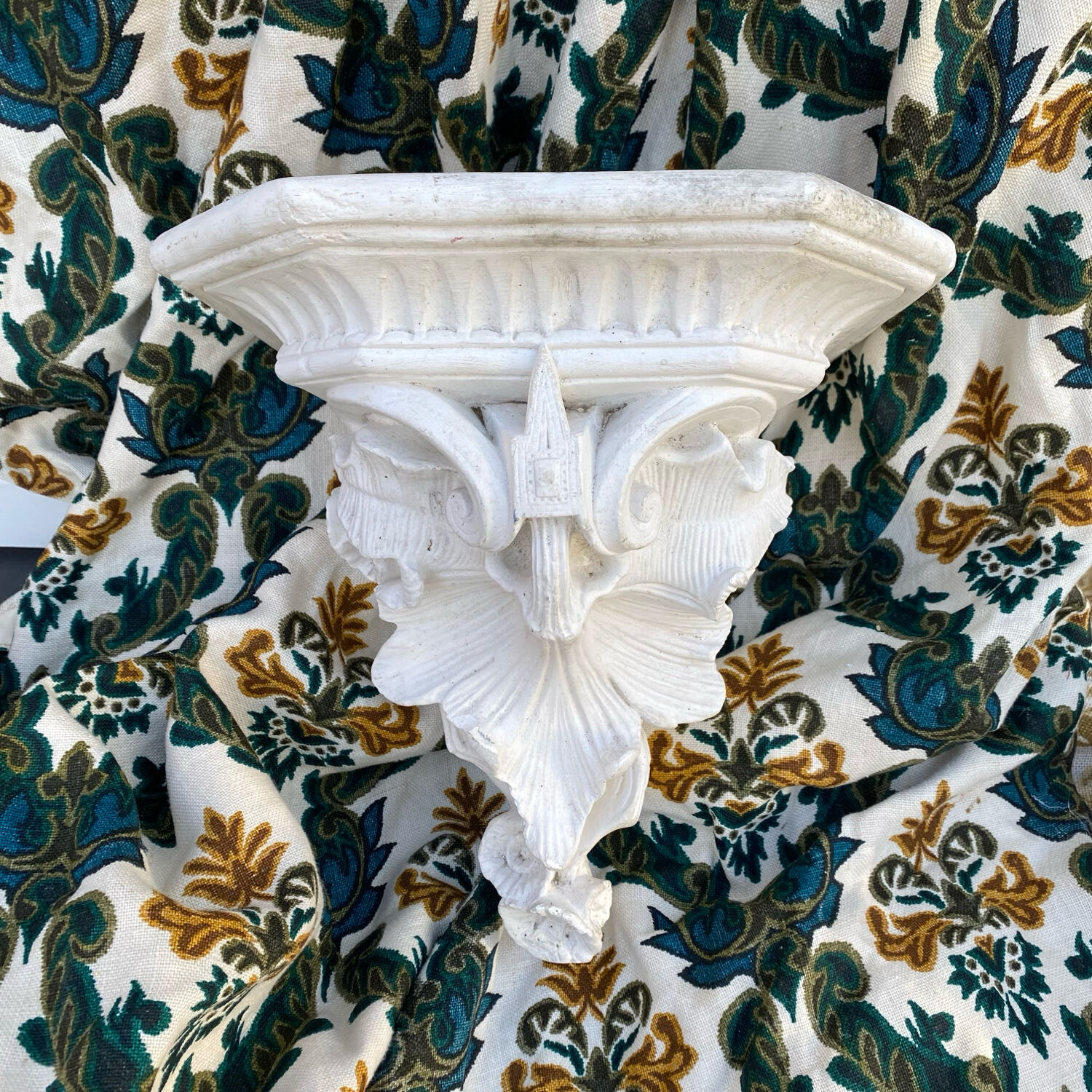 Antique wall console in patinated white plaster.