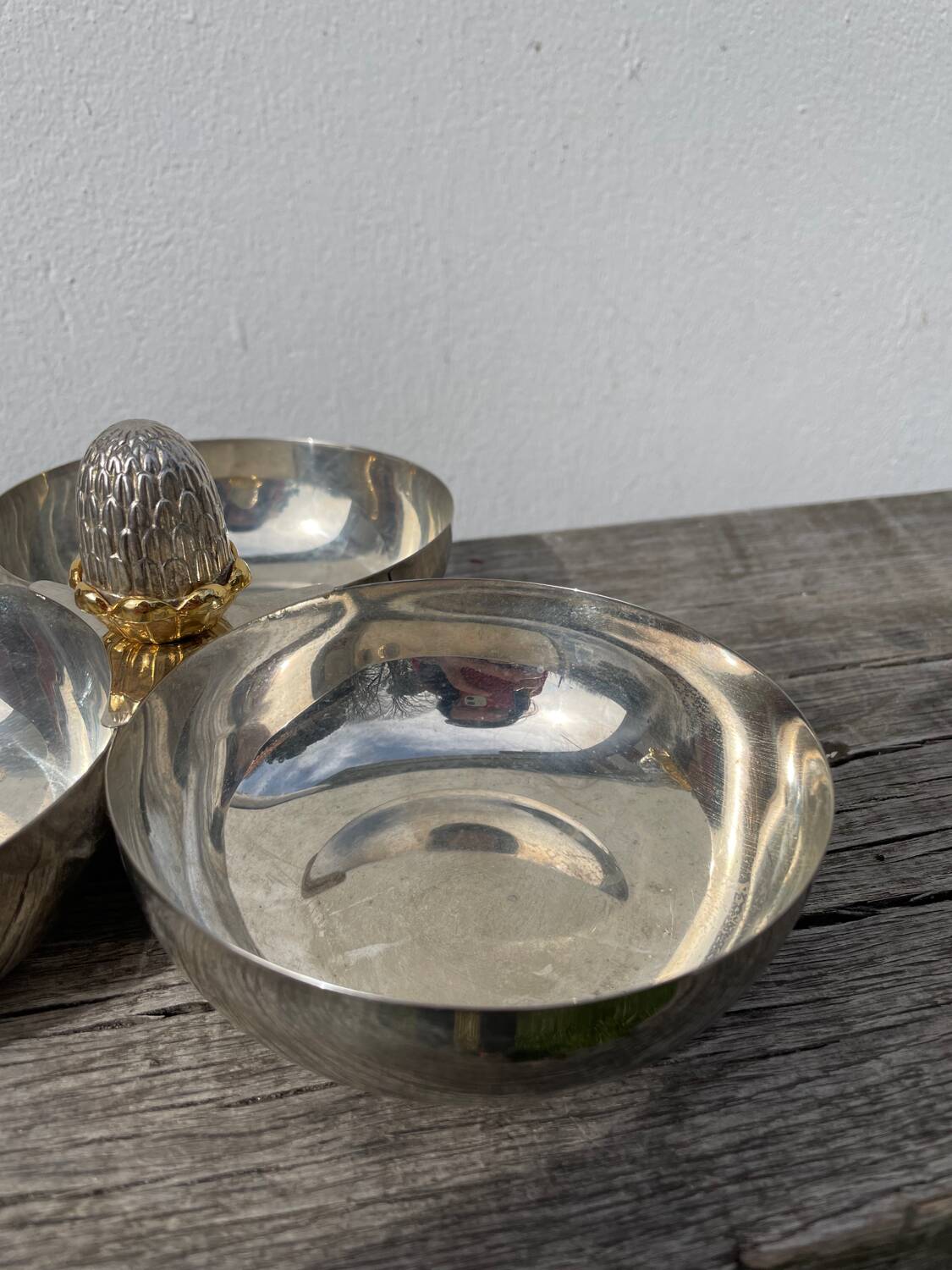 Silver-plated metal dish topped with an acorn