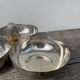 Silver-plated metal dish topped with an acorn