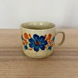Speckled stoneware cup with blue flower