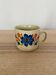 Speckled stoneware cup with blue flower