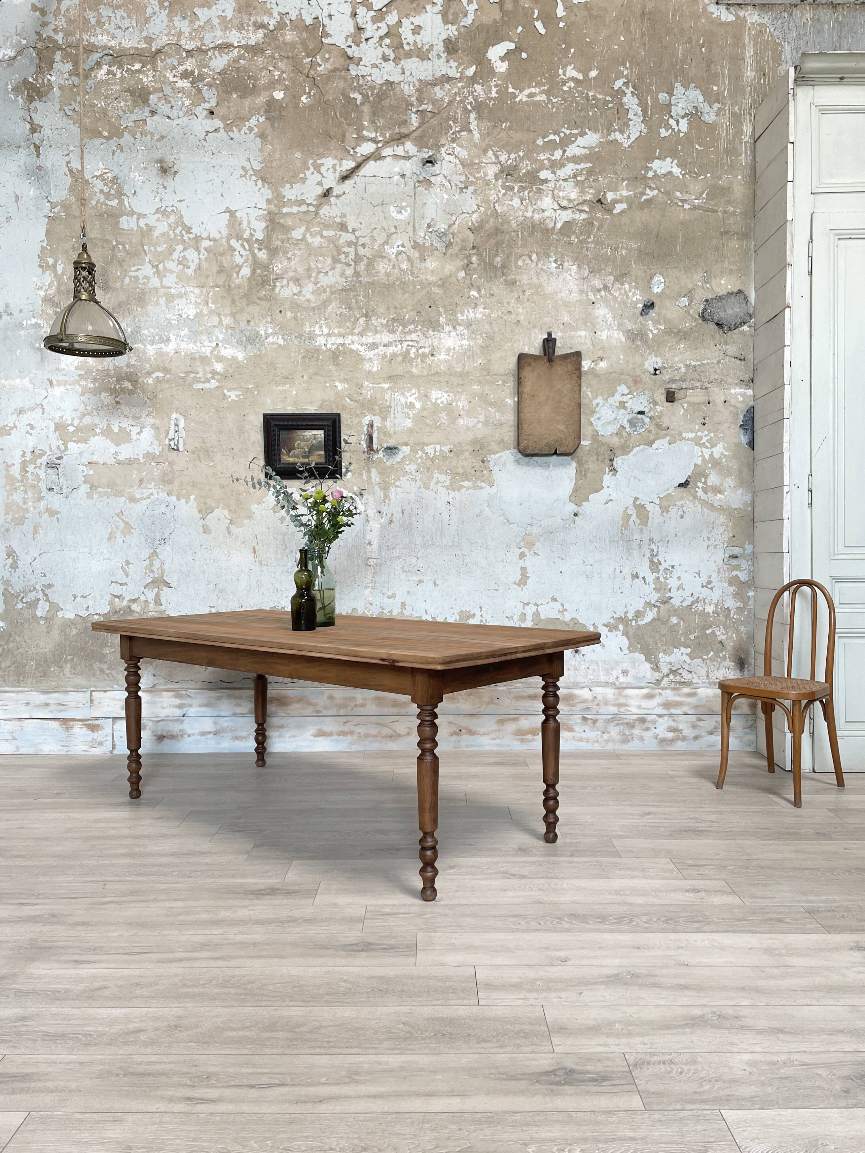 Vintage farmhouse table with turned legs.