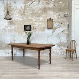 Vintage farmhouse table with turned legs.