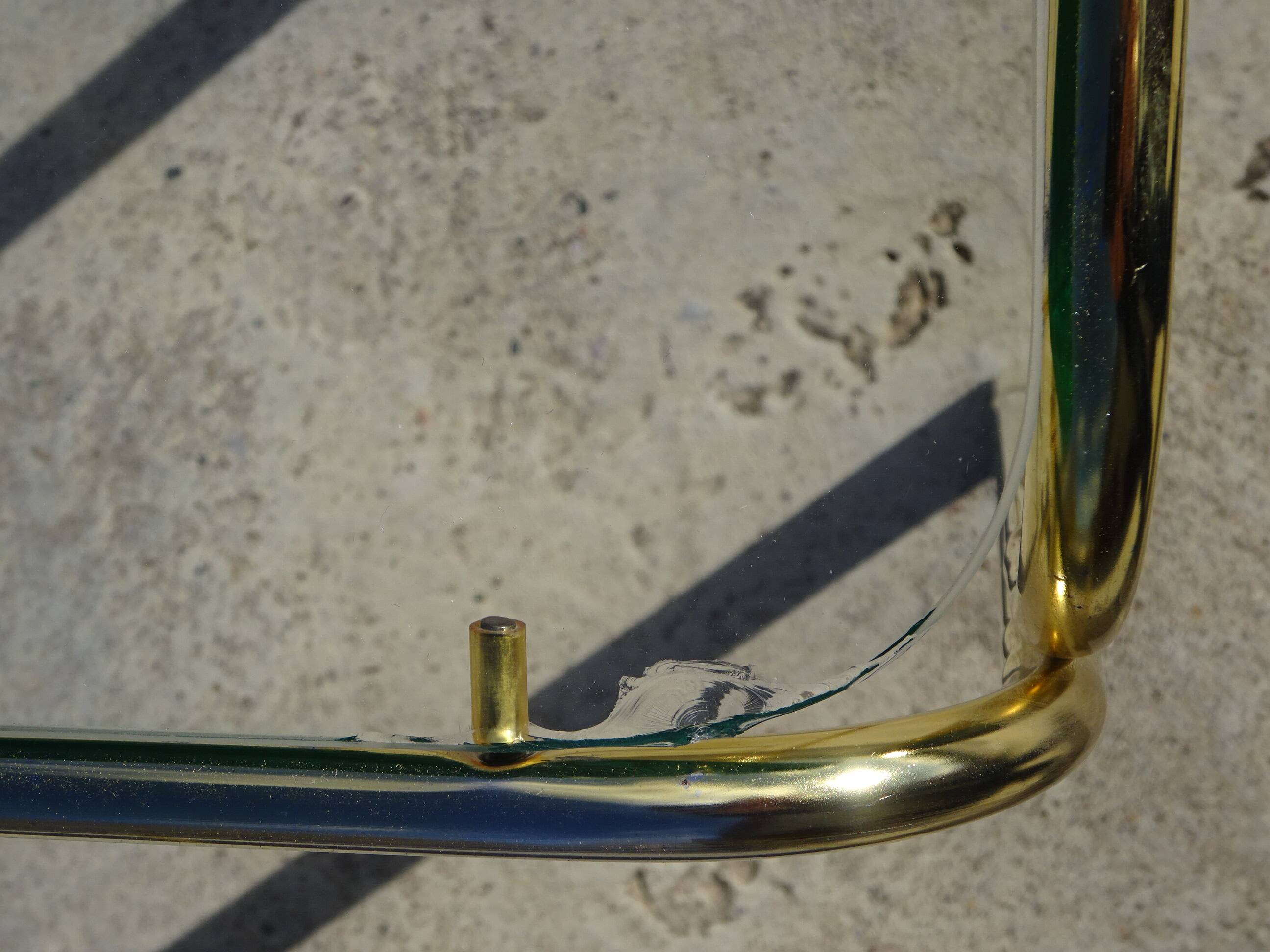 Nested tubular tables in gold metal.