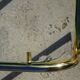 Nested tubular tables in gold metal.