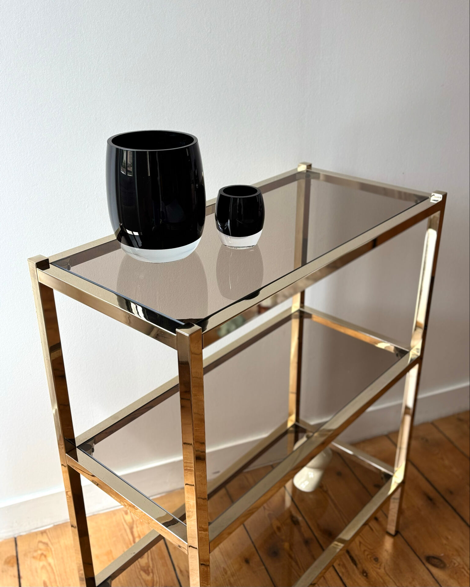 Brass and smoked glass library shelves