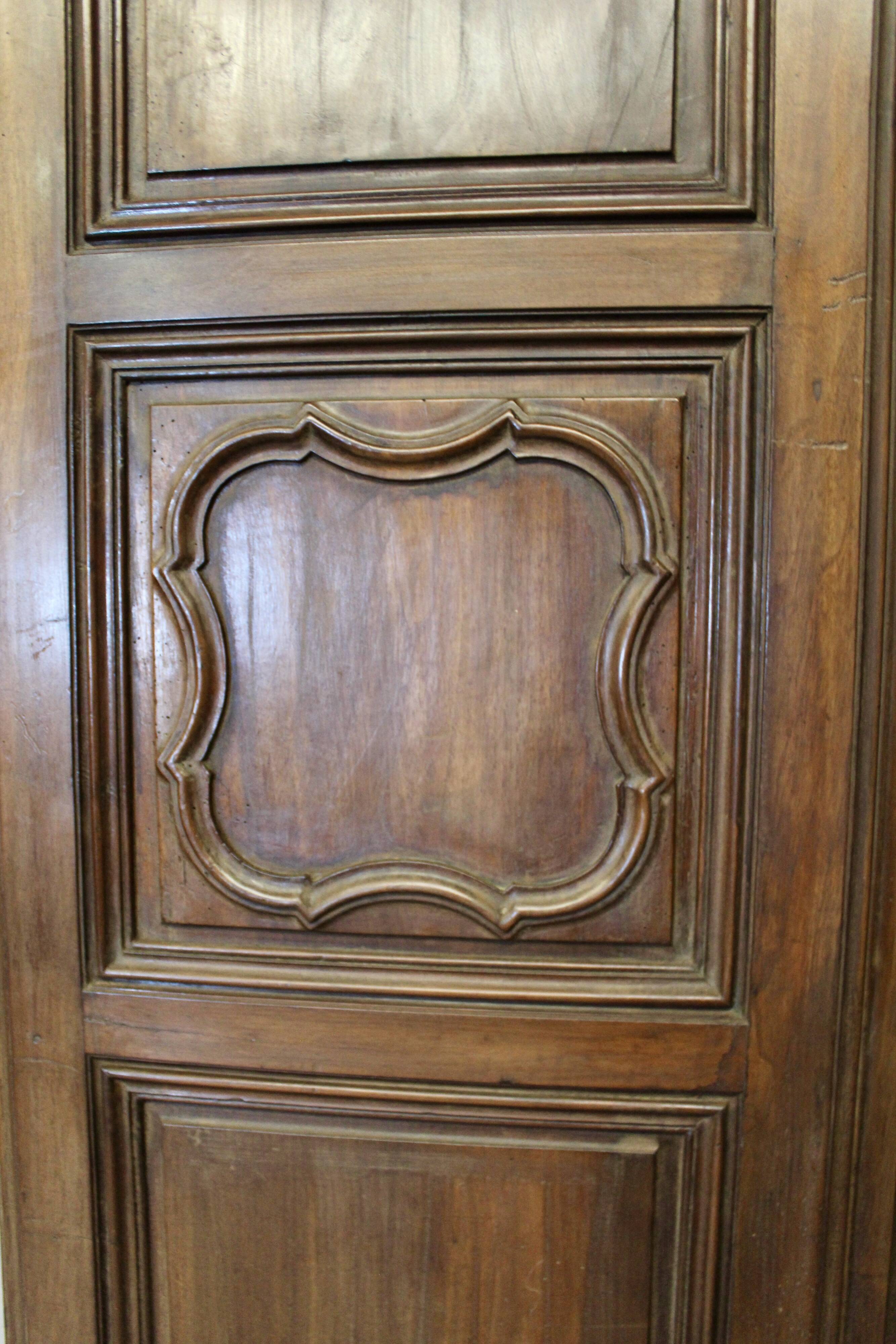 Pair of Louis XV walnut doors with medallion