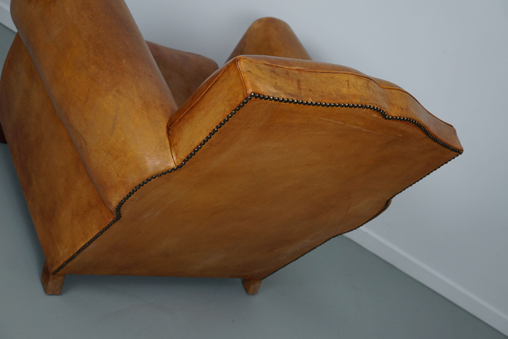 Vintage french moustache back cognac-colored leather club chair