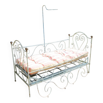 Vintage children's bed with mattress and quilt
