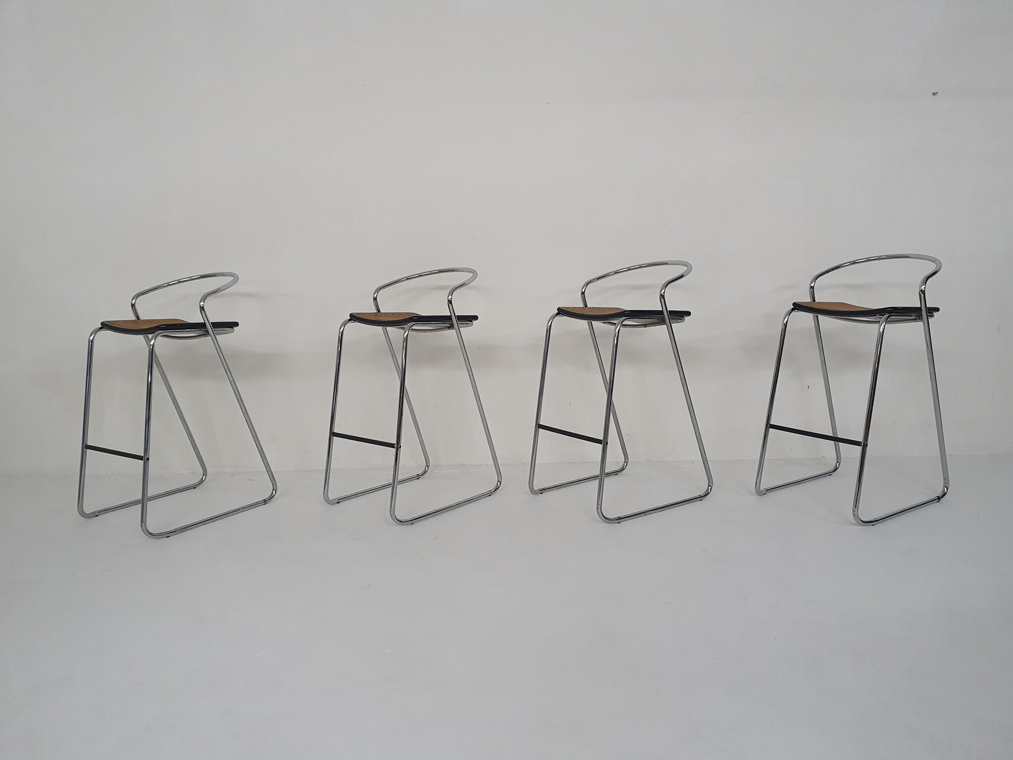 Set of four chrome and cane bar stools, 1970's