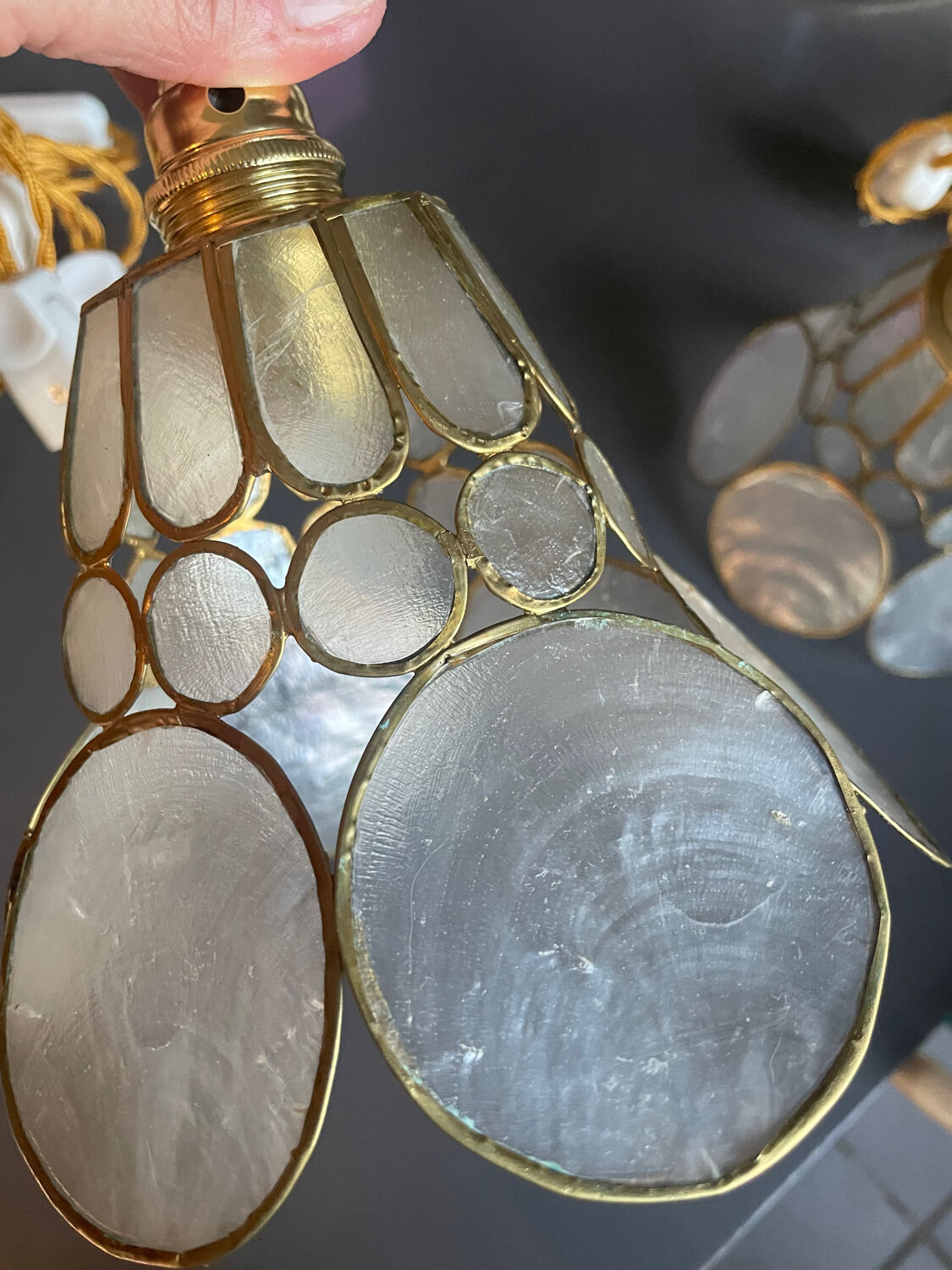 Pair of portable lamps with mother-of-pearl lampshades and brass.