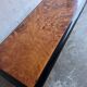 Vintage coffee table in wood burl on a black lacquered base.