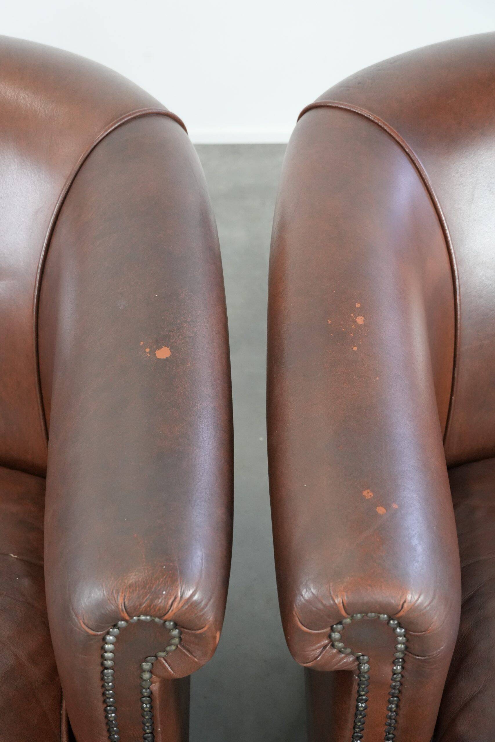 Unique set of two cognac-coloured cow leather club armchairs
