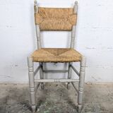 Rustic chair made of turned wood and straw.