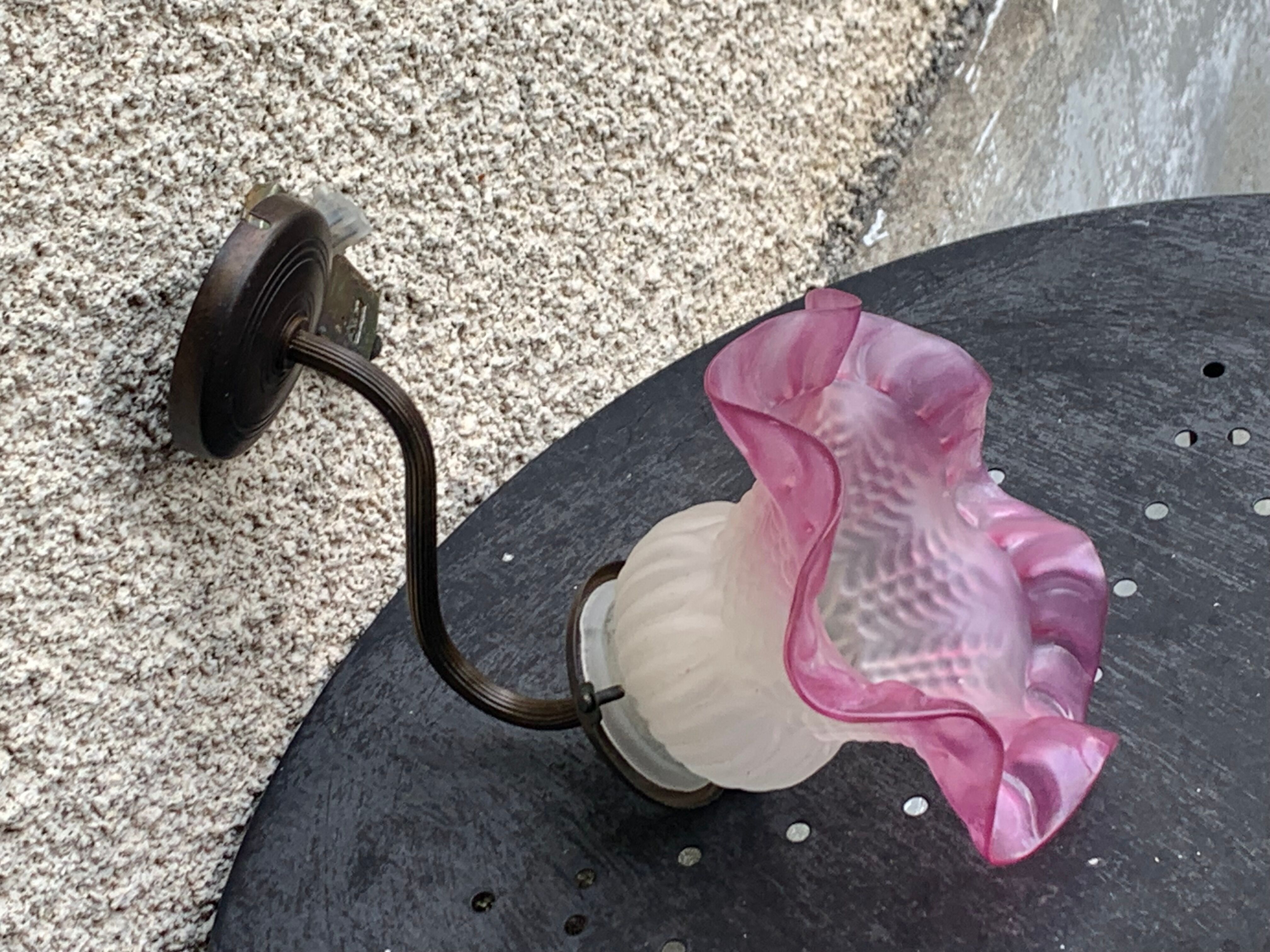 Metal wall lamp with frosted glass shade in the shape of a pink corolla
