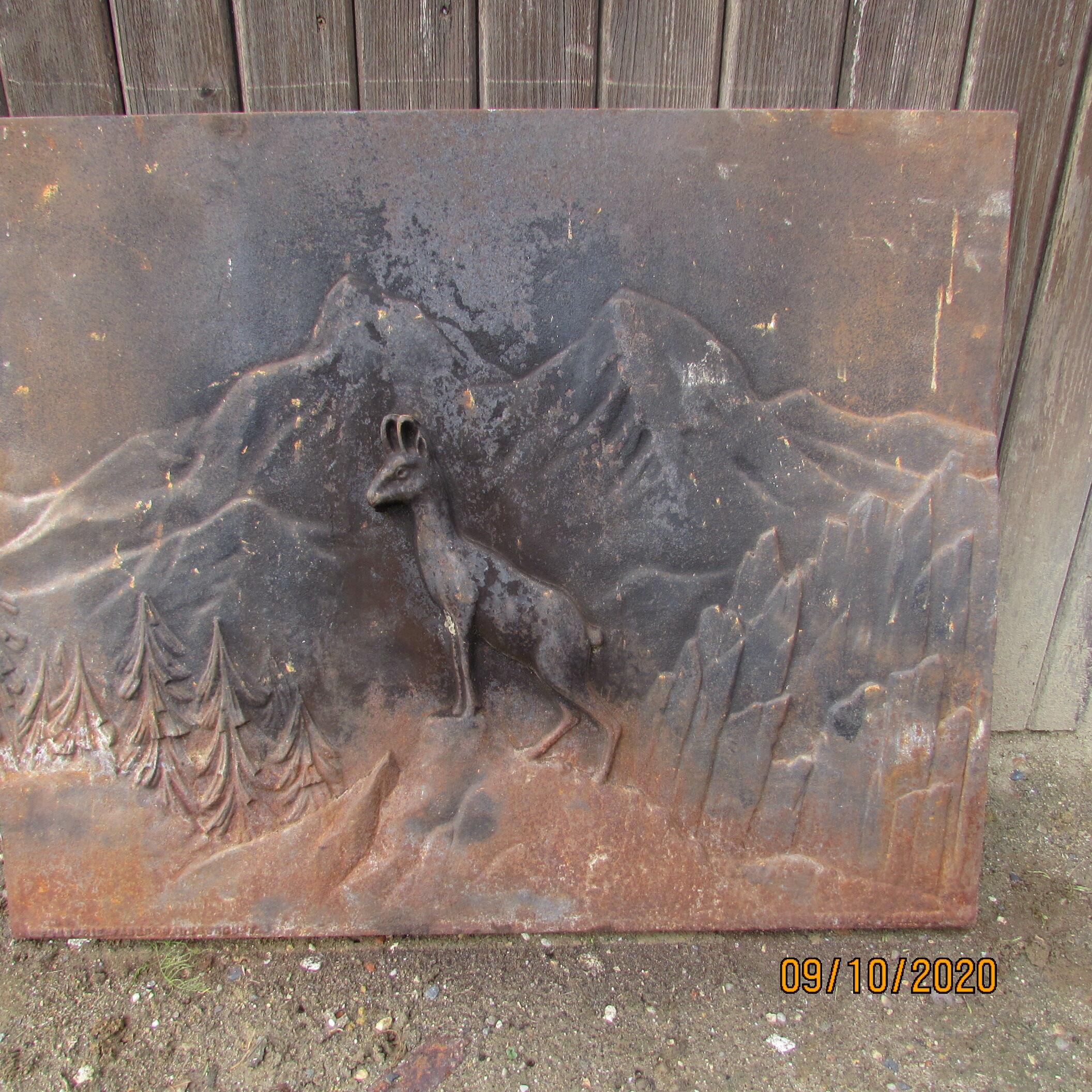 Old cast iron chimney plate