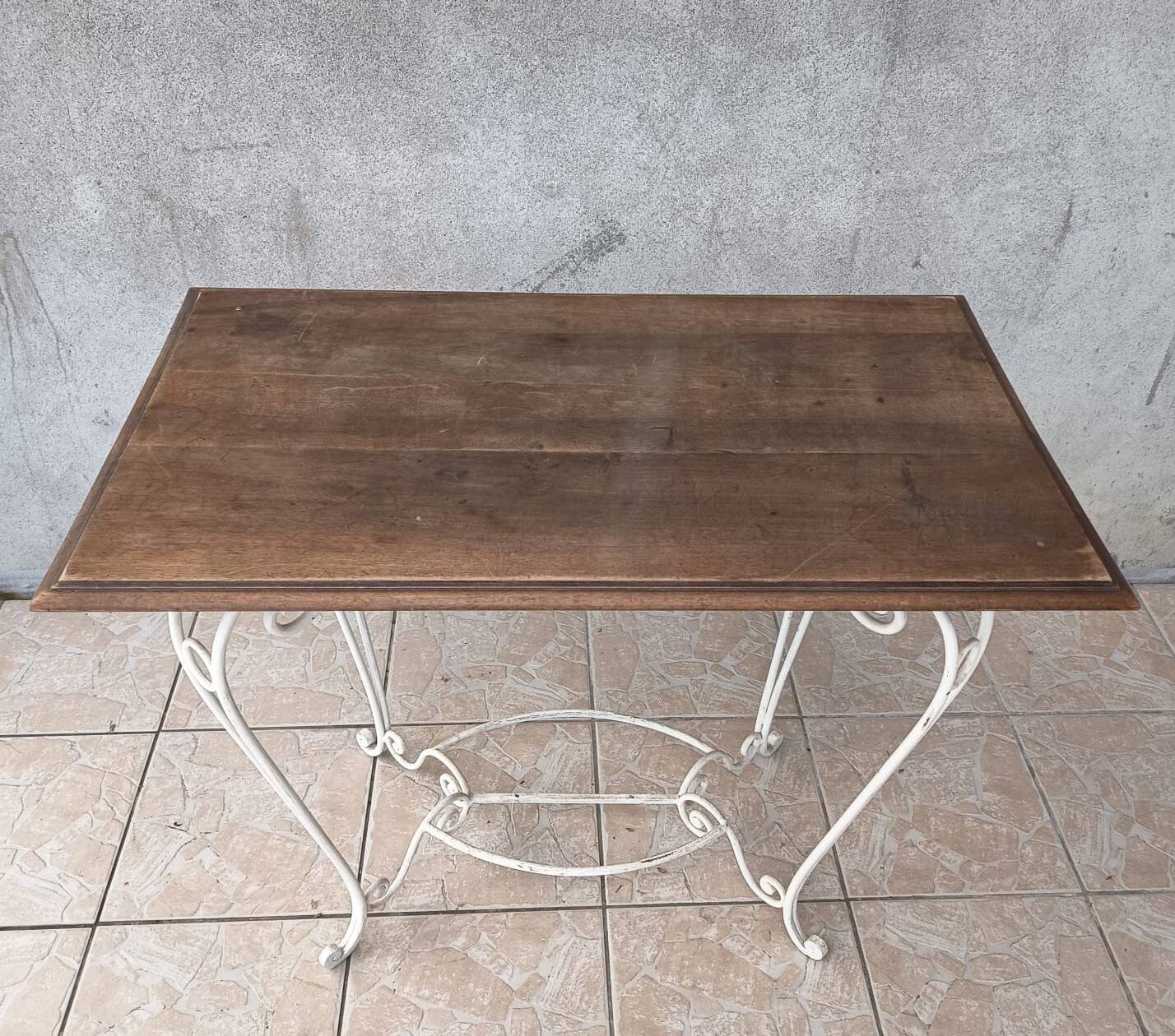 Wrought iron table with a walnut top.