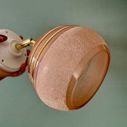 Vintage globe wall light in frosted pink and gold glass.