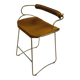 Bar stool with a vintage brass backrest and natural brown leather.