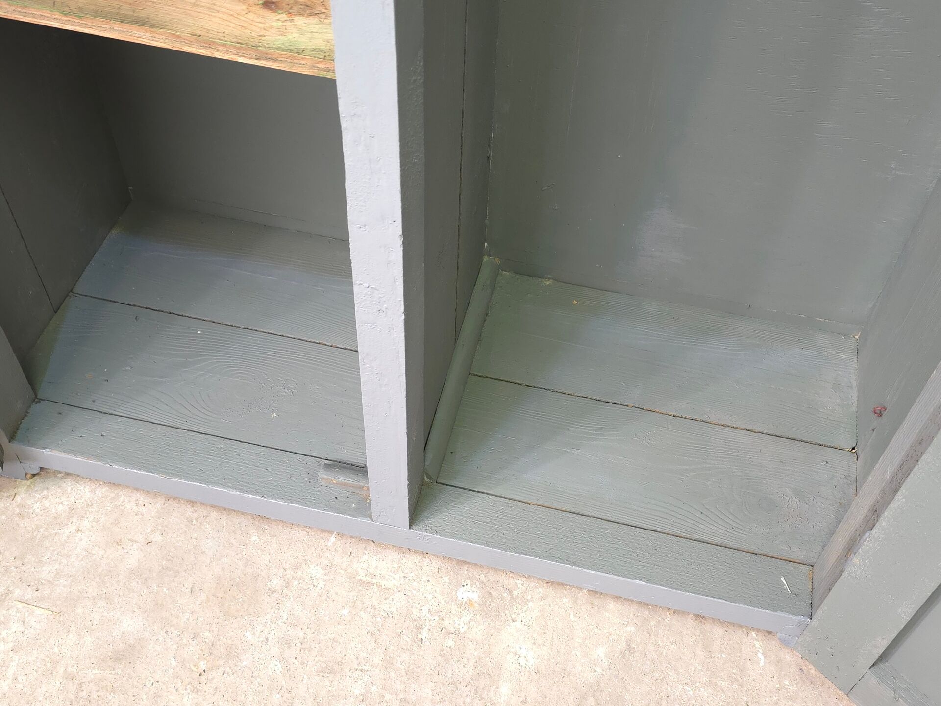 Curved wardrobe workshop locker made of wood repainted in grey.