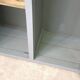 Curved wardrobe workshop locker made of wood repainted in grey.