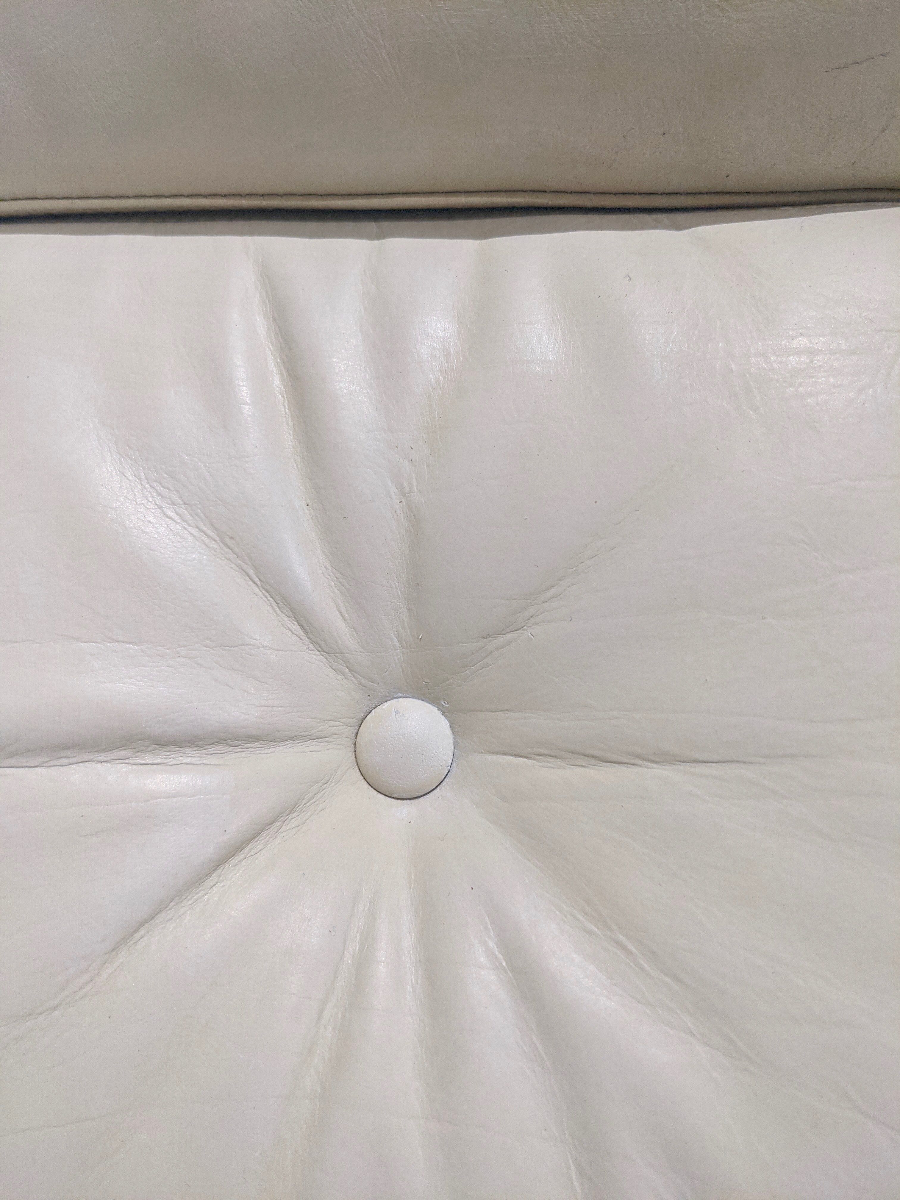 Swivel armchair in grey patinated leather