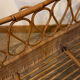 Vintage rattan baby cot on wheels.
