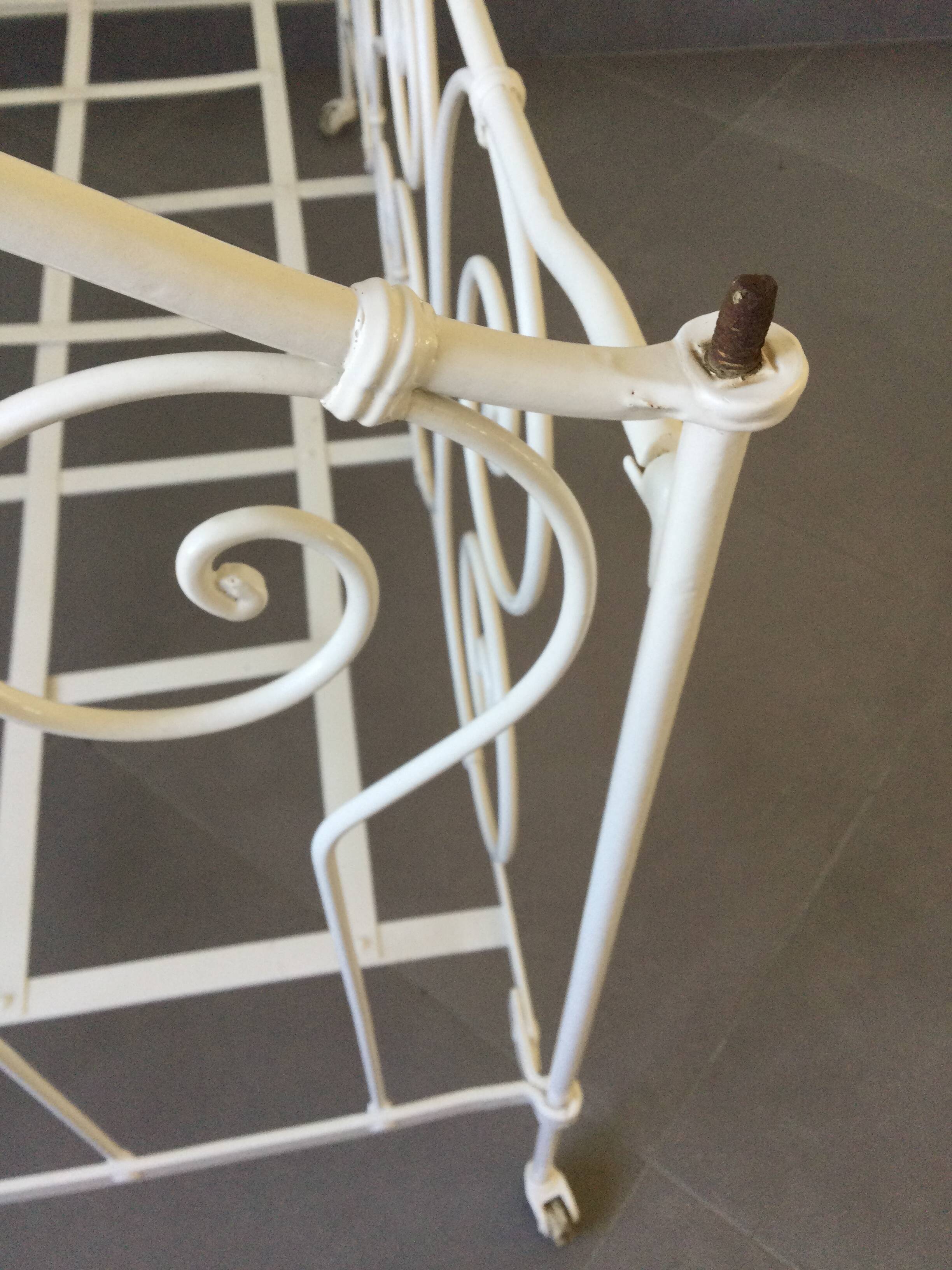 White wrought iron folding bed