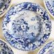 Five 19th century Calais earthenware plates with a romantic gallant couple decor