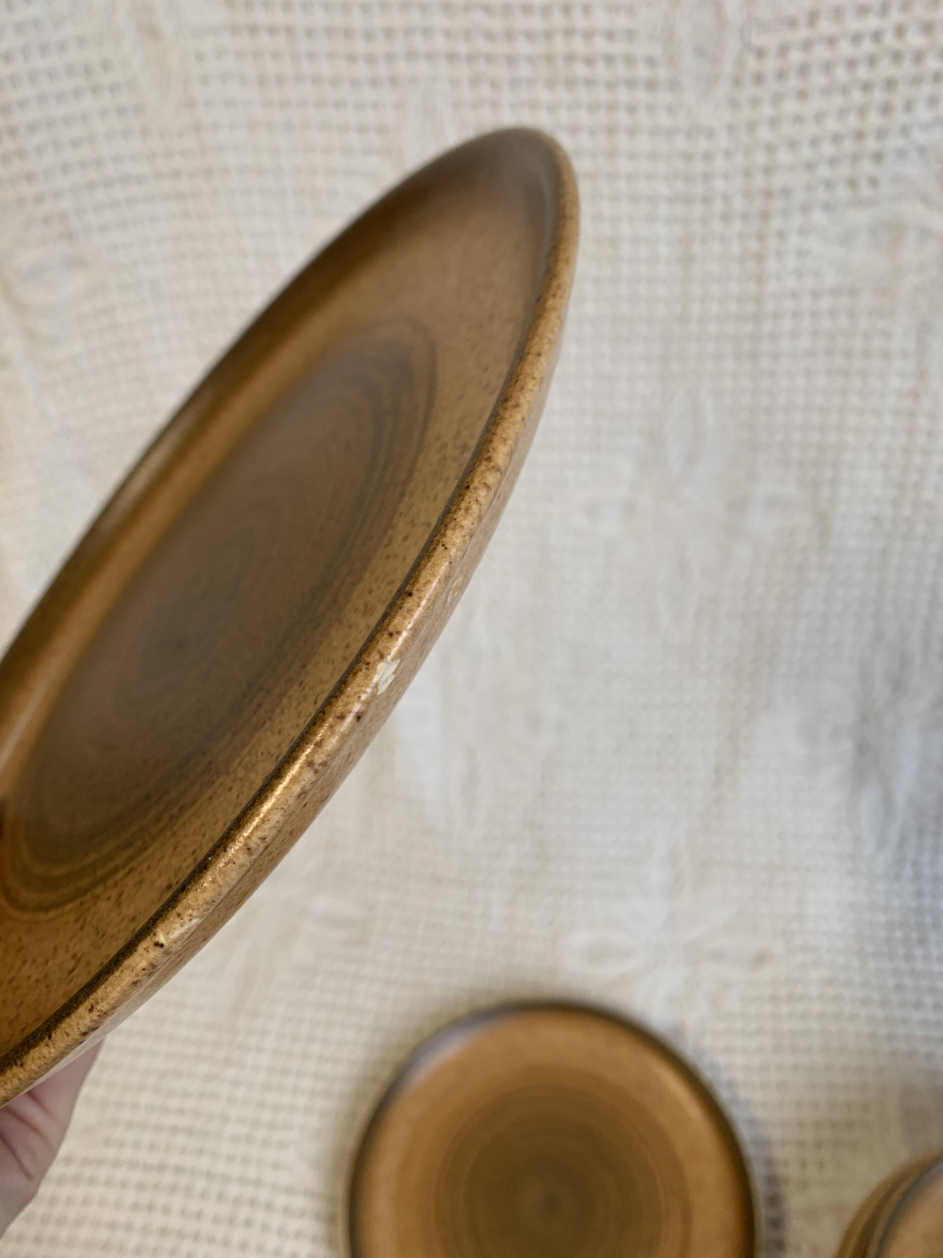 8 Longchamp enamelled stoneware plates, 1970